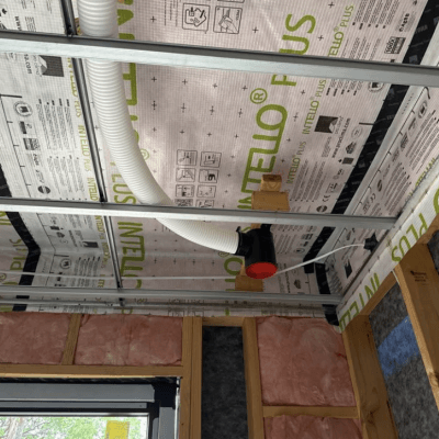 MVHR duct terminal being installed through Intello Plus airtight membrane