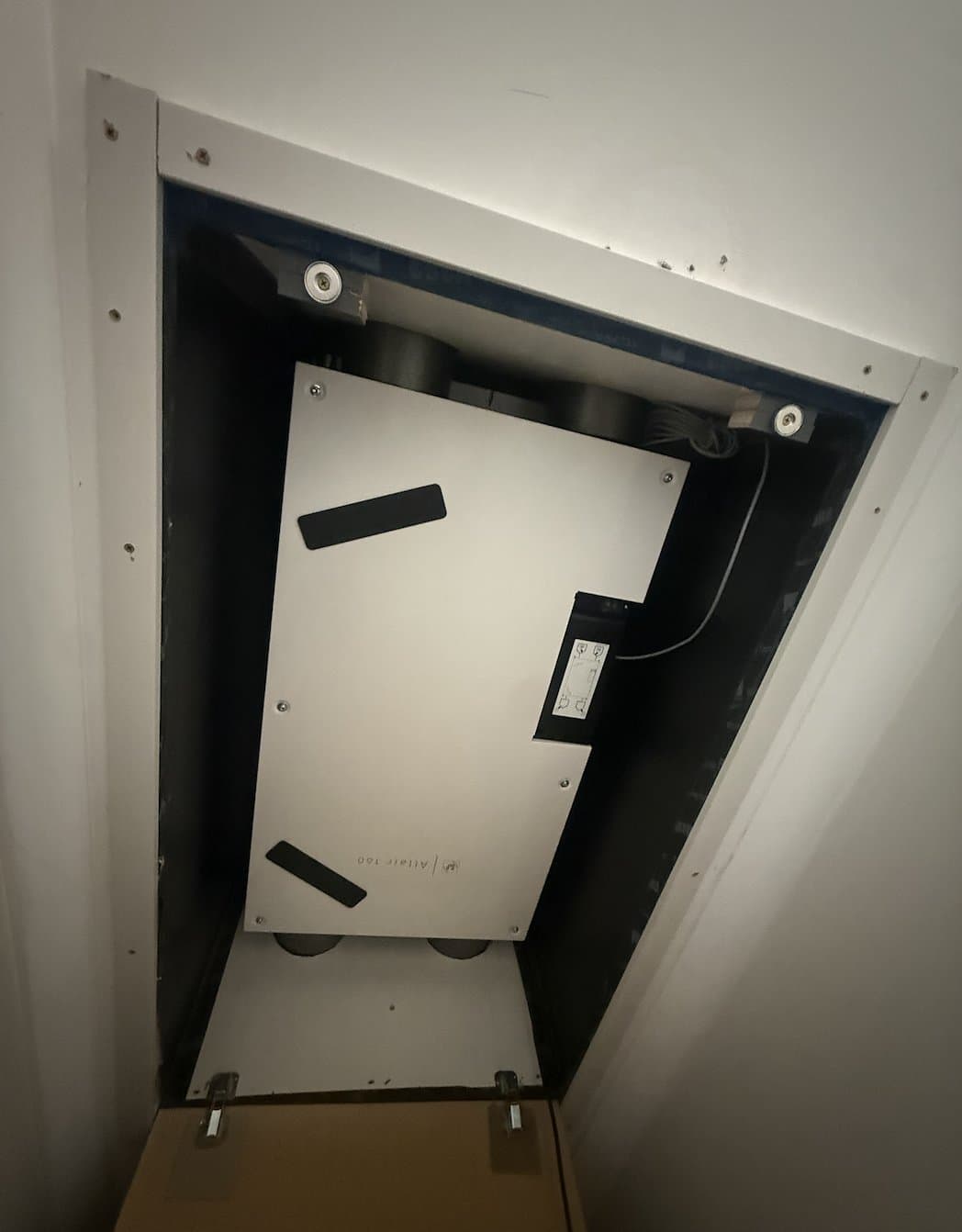 Altair 160 MVHR unit installed in a ceiling riser cavity at the Nairne retrofit, accessed through a roof hatch