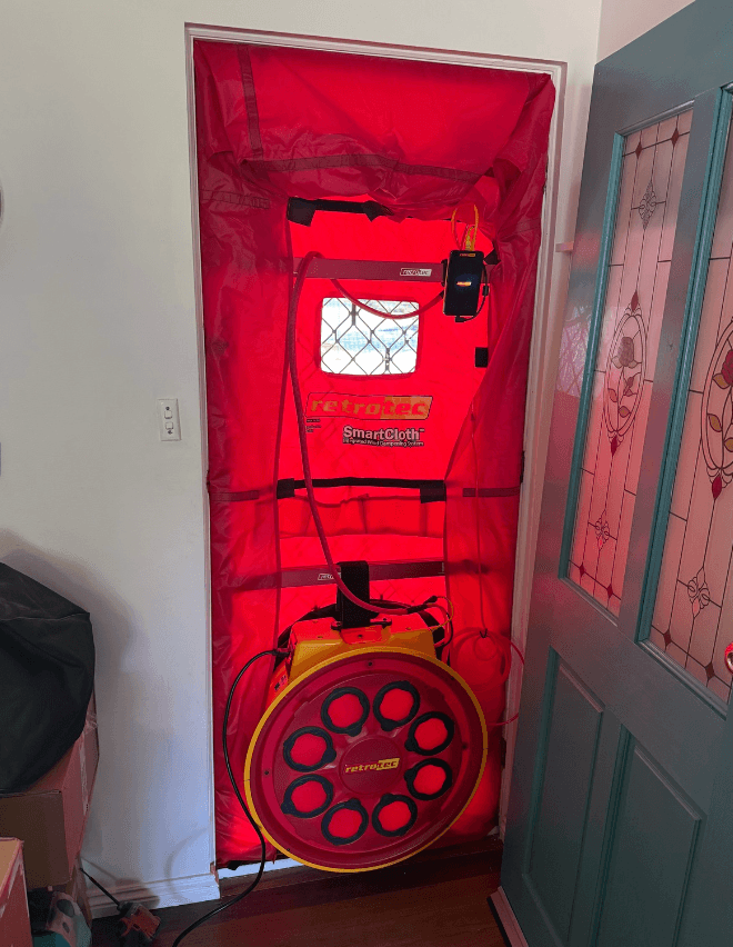A Retrotec blower door fan installed in an external doorway during an airtightness test